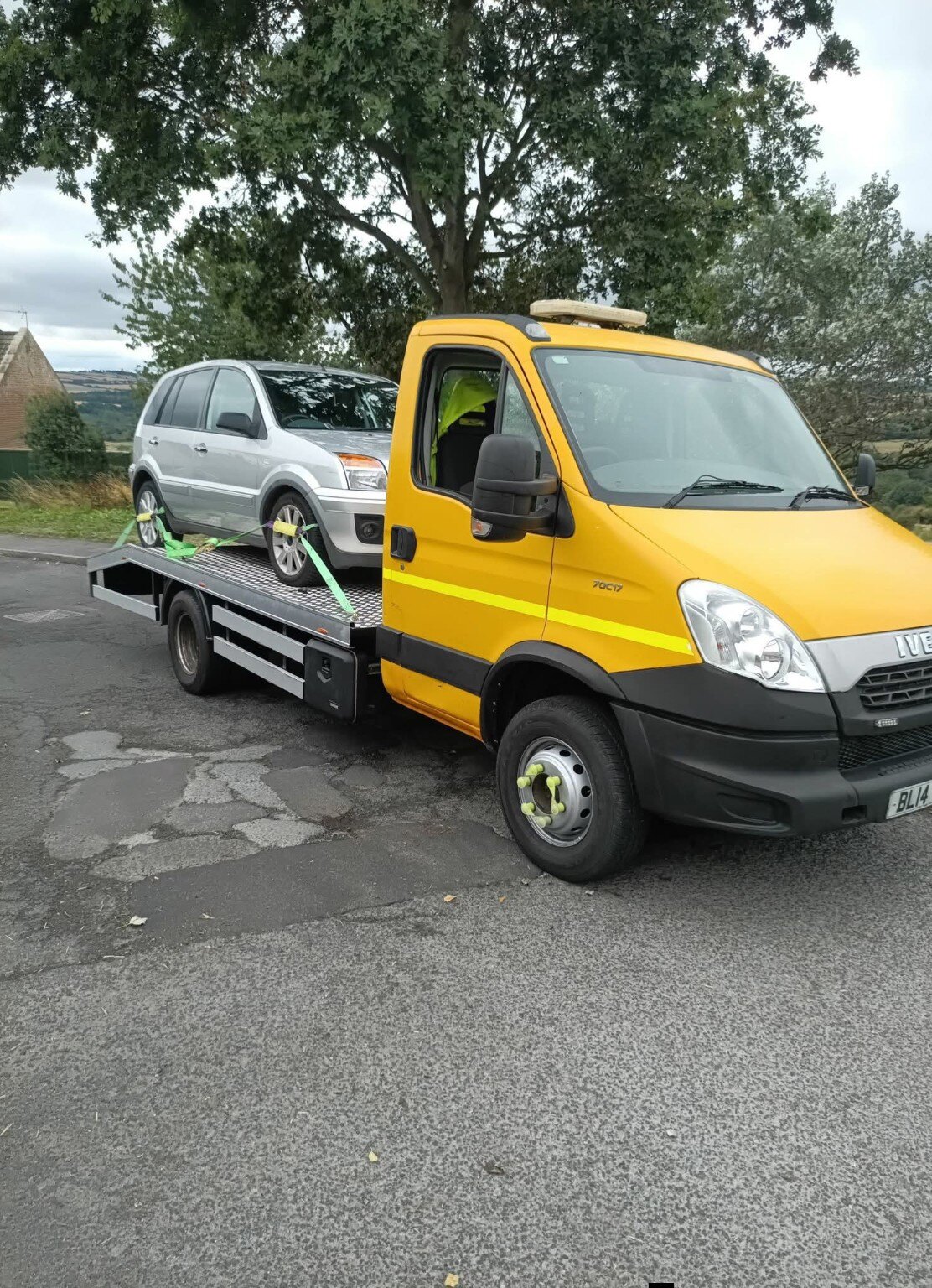 Yellow Workhorse Recovery truck transporting a silver Ford