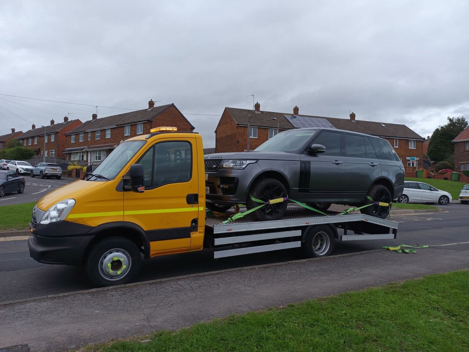 Yellow Workhorse Recovery truck transporting a Range Rover